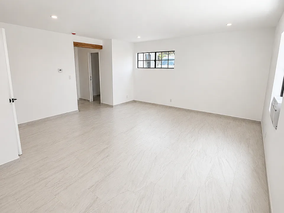 Bright and airy living room with access to spacious patio.