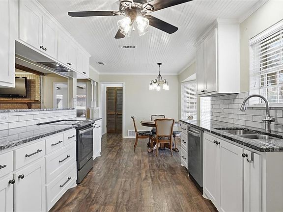 Remolded kitchen with beautiful granite, tiled backsplash & counter & cainets galore...
