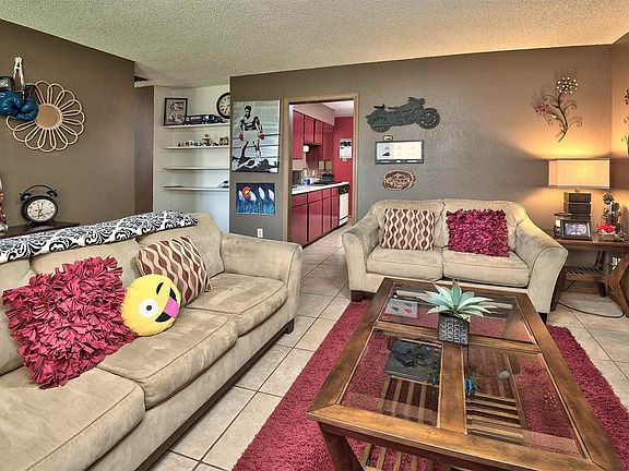 The entry leads into a cozy living room, with the kitchen and dining area just b