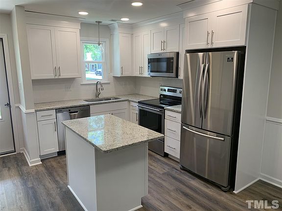 White , Bright kitchen with stainless appliances, granite & island