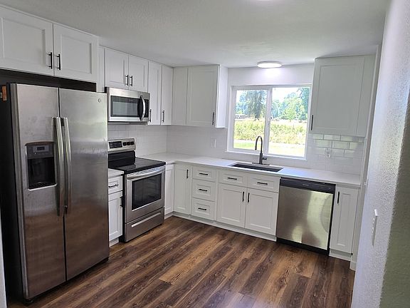 Newly remodeled Kitchen with plenty of cabinet space. Fridge, dishwasher, stove and microwave.