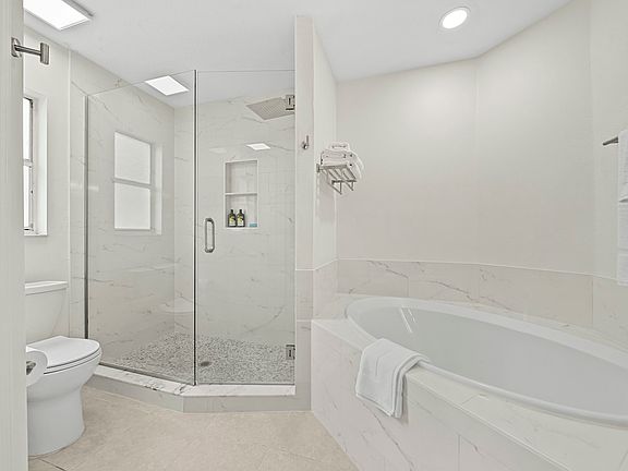 Feel pampered in the Newly renovated bright clean en suite bath with tiled walk-in frameless door rainshower has a spa-like feel.