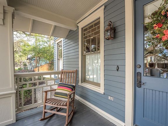 One of the two front porches to sit and enjoy the beautiful oak lined street. Notice the details in the trim work,  the columns and porch railings.