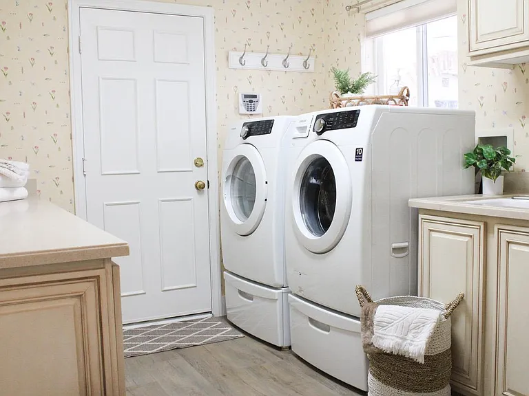 Large laundry room with washer and dryer included.