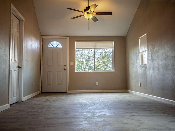 Living room. Wood floors, ceiling fans, vaulted ceiling.