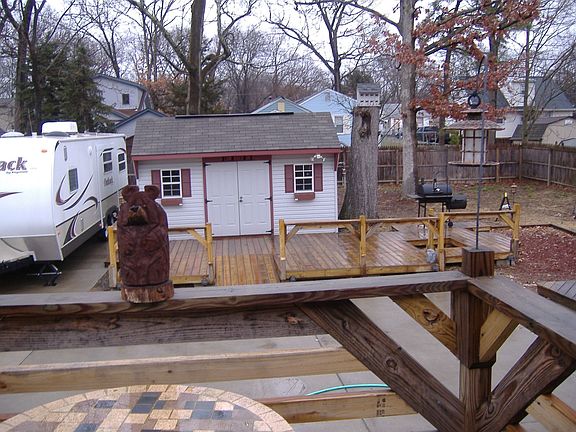 large backyard with outbuilding and concrete 