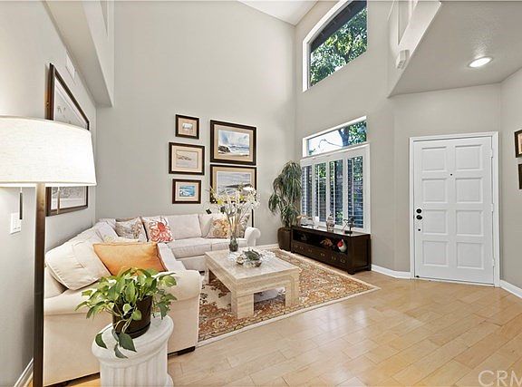 Gorgeous light-filled living room with high ceilings at entrance to home.
