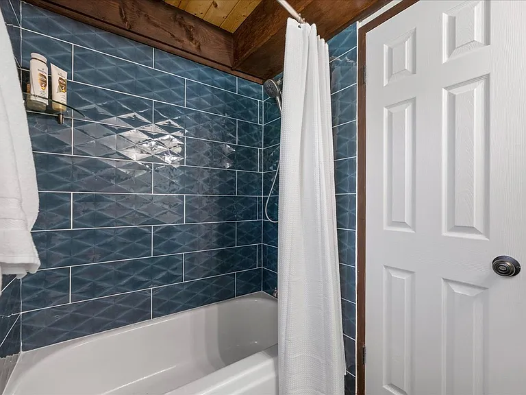 Remodeled bathroom with tub/shower combo downstairs.