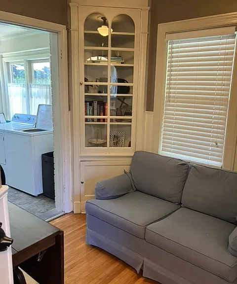 Reading room with bookshelf next to laundry room.