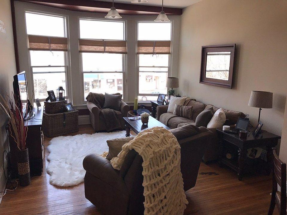 Living room with large bay windows overlooking downtown Syca