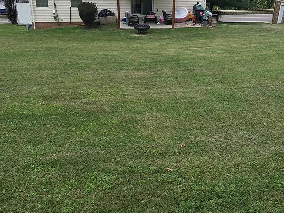 Glass sliding door to Patio with ceiling fan and beautiful private yard.