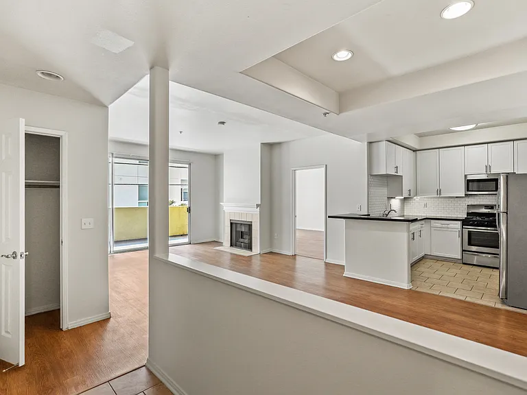 Front Entrance with Hall Closet, Dining Room, and Kitchen