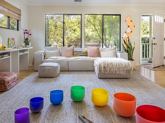 Living room looking out onto maple tree & lavender garden in front yard