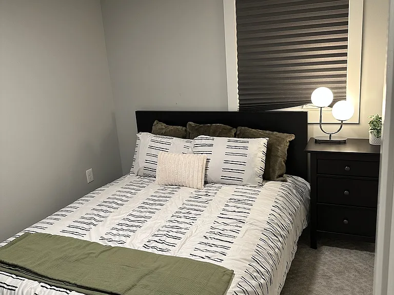 Cosy Queen Sized Bedroom equipped with nightstand, dresser, large closet, and a smart TV.
