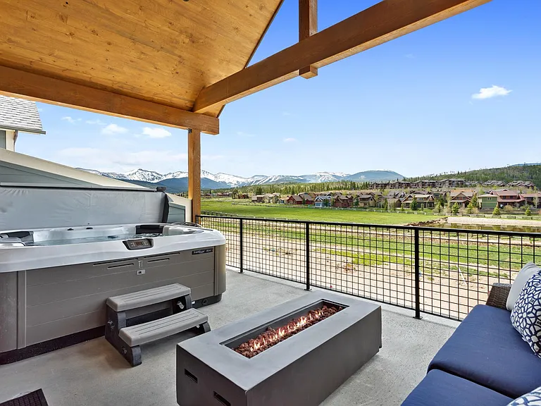 Third level covered patio with hot tub and fire pit