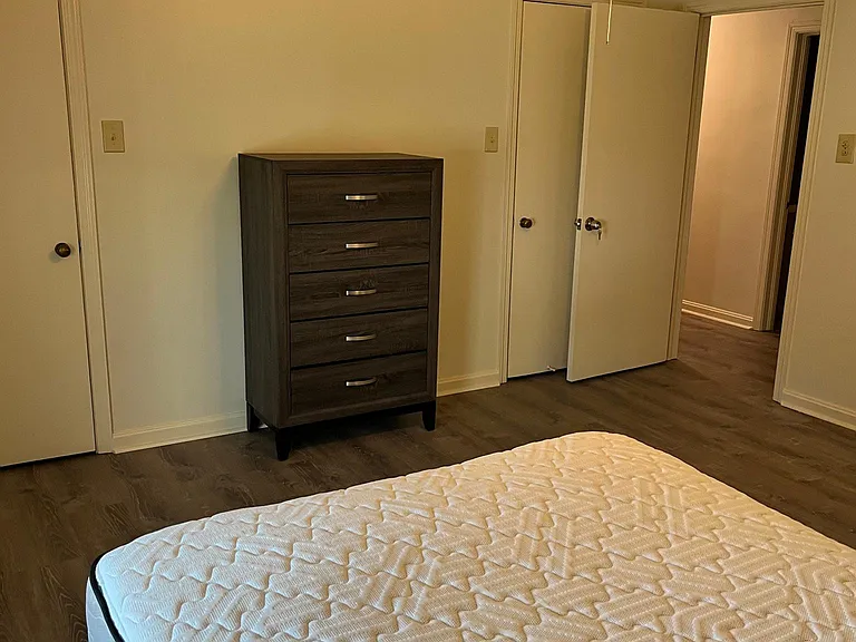 Room A - Door opens to community hallway and bathroom right across the hall, dresser in between two closets