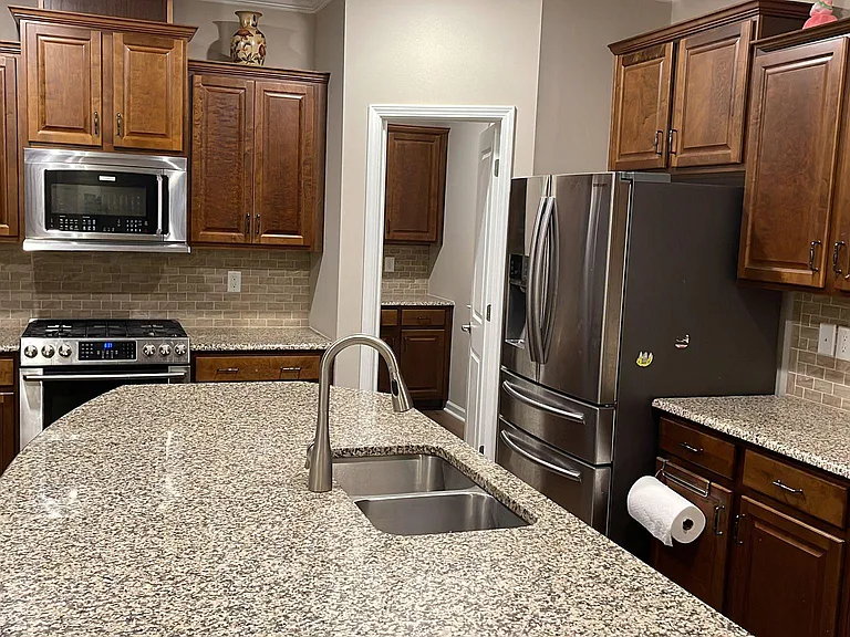 Kitchen with cabinets + Samsung Refrigerator