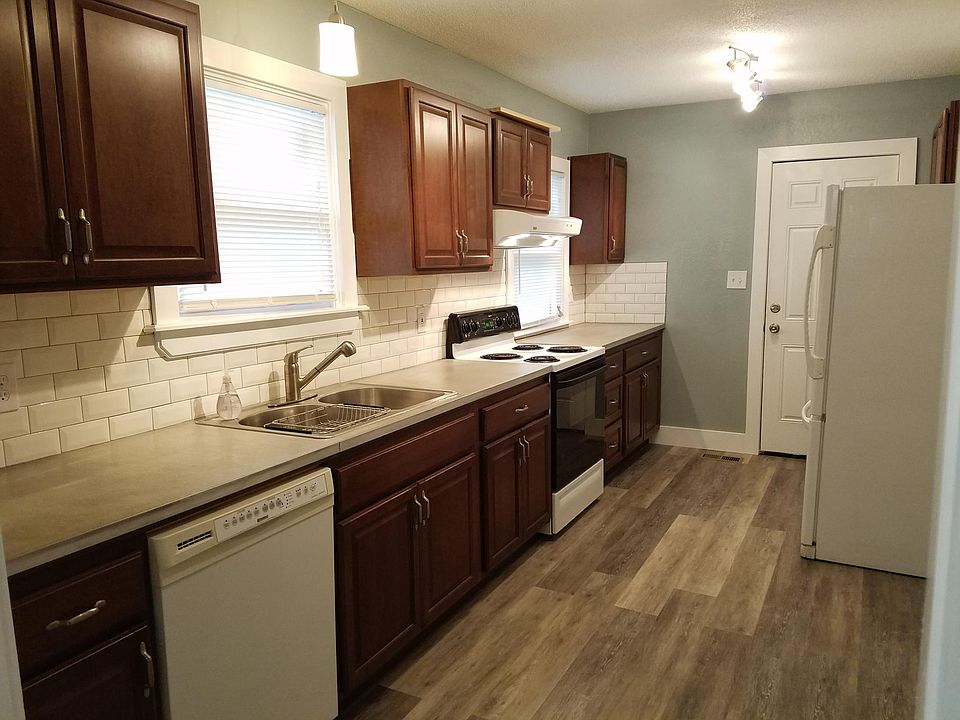 Custom concrete counter tops show off the beautiful cabinets, back splash, and extra large kitchen.