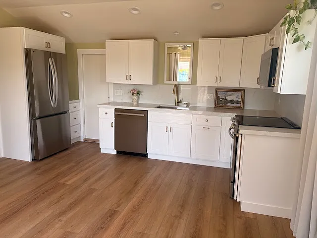 New appliances in kitchen. Pantry is adjacent to refrigerator. - Egret Ave