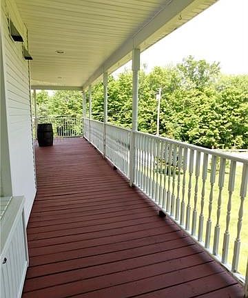 Wrap-around porch provides views of the yard along with plenty of entertainment options.
