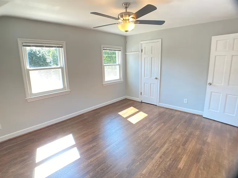 Primary bedroom - new ceiling fan, generous closet space, all new cordless blinds.
