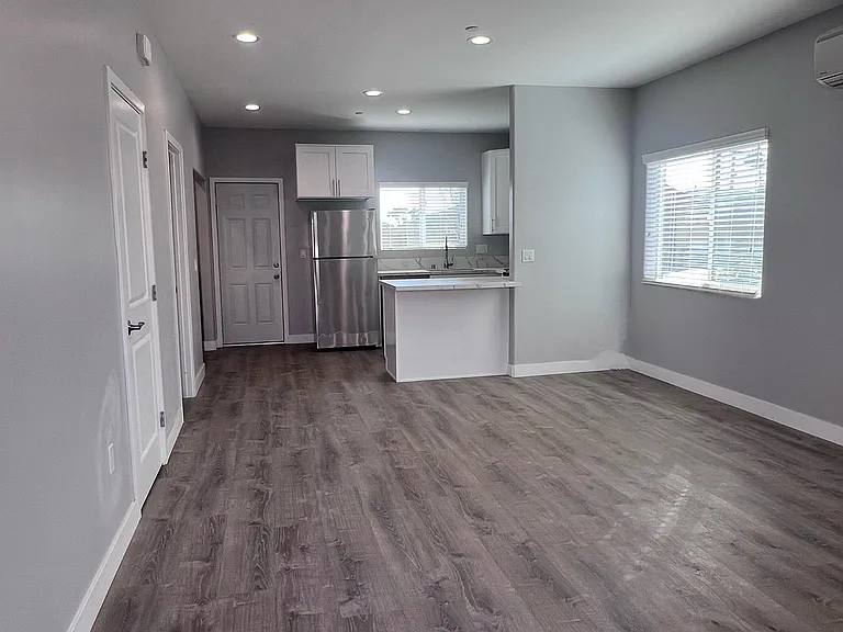 View from the entry way - Bright LED lights and lots of windows for natural light. Vinyl laminate flooring.