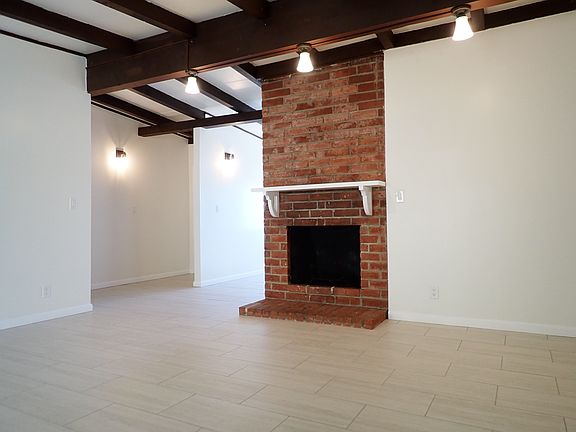 Living Room w/ vaulted ceilings and fireplace