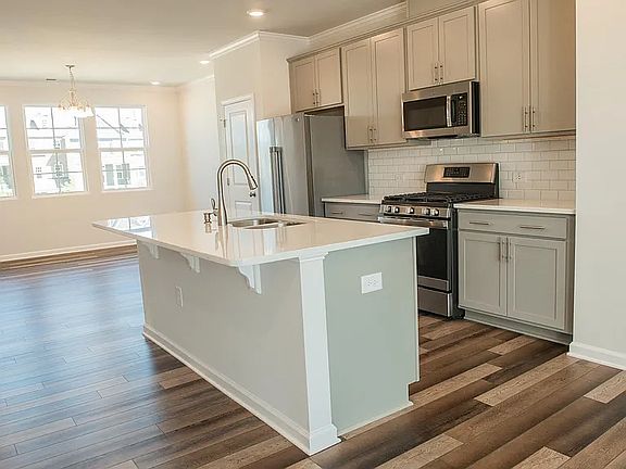 Kitchen with stainless steel appliances and quartz countertop