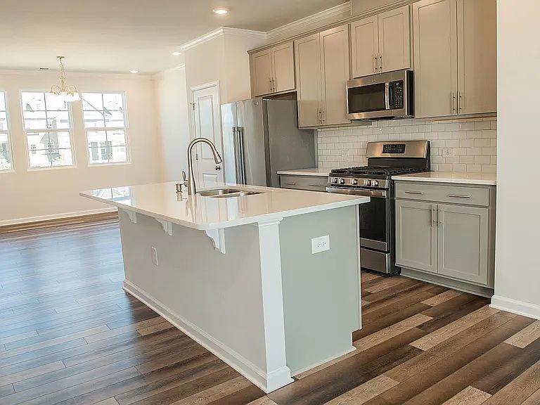 Kitchen with stainless steel appliances and quartz countertop