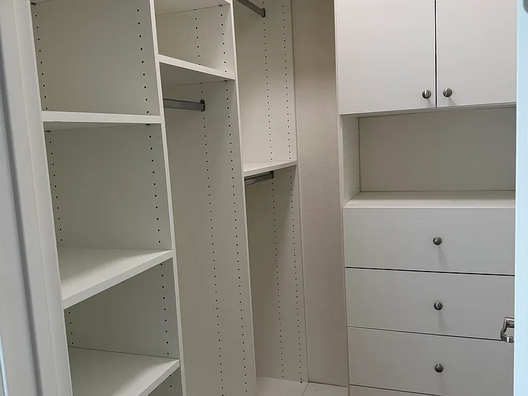 Finished walk-in closet attached to downstairs bedroom