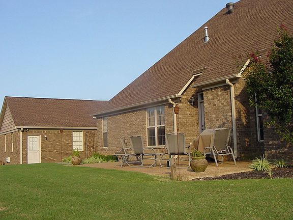 backyard with view of detached garage