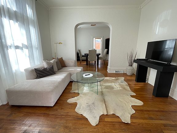 As you enter you find bright double living/dining rooms with high ceilings and period details