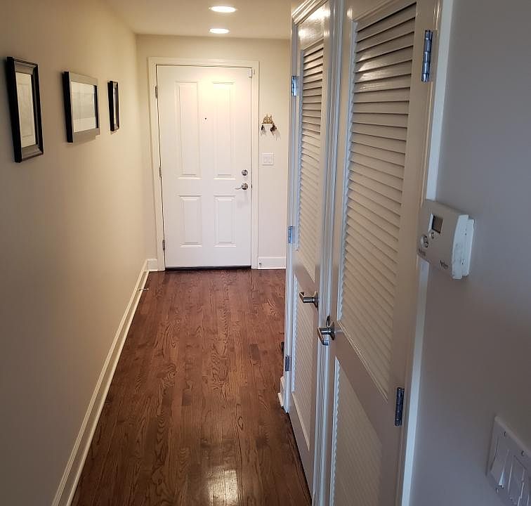 Main hallway with coat closet in entryway and washer & dryer.