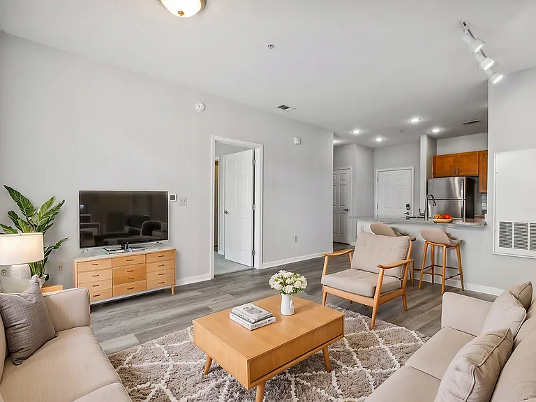 Welcome to this inviting open concept living room. The room flows seamlessly into the kitchen with convenient place for breakfast bar seating. Track lighting complete this bright, airy living space perfect for both relaxation and entertaining. Natural lig