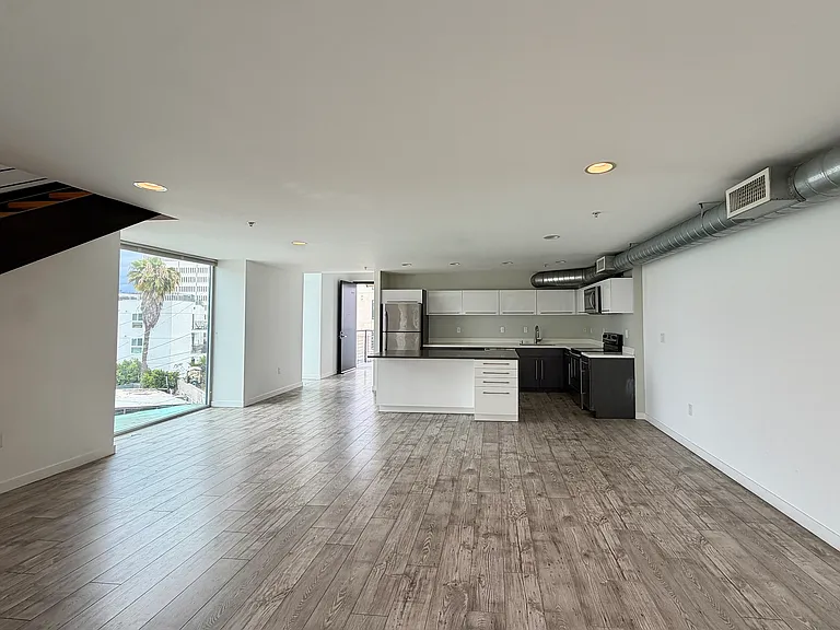 Expansive first floor living area. Well lit kitchen and island.