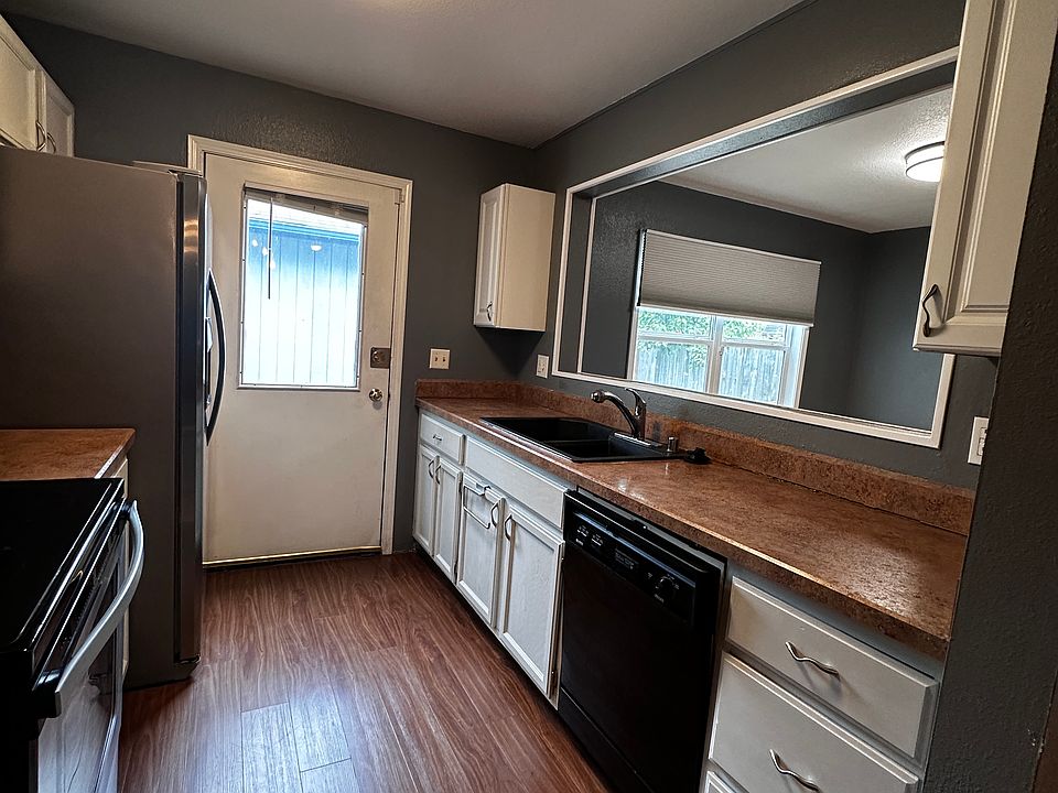 Kitchen with stainless appliances, including water/ice maker in fridge.