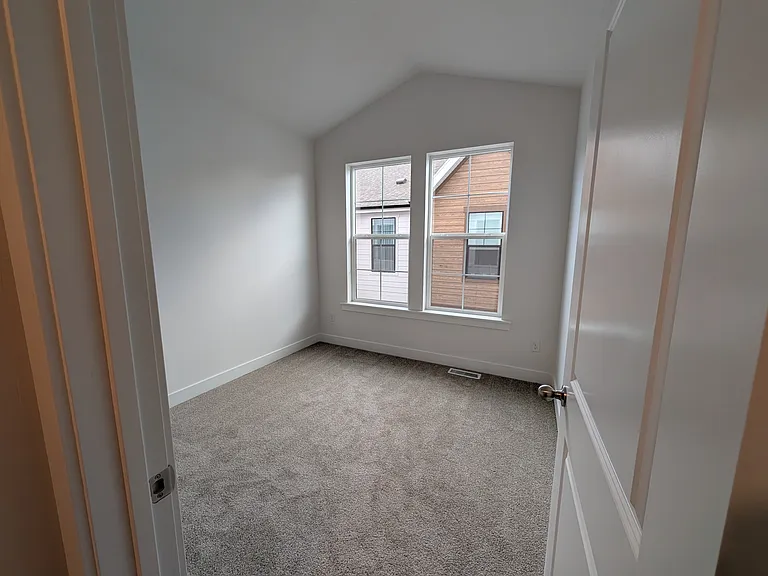 Bedroom 1. All bedrooms have vaulted ceilings and large windows. Great closet space with built in shelving.