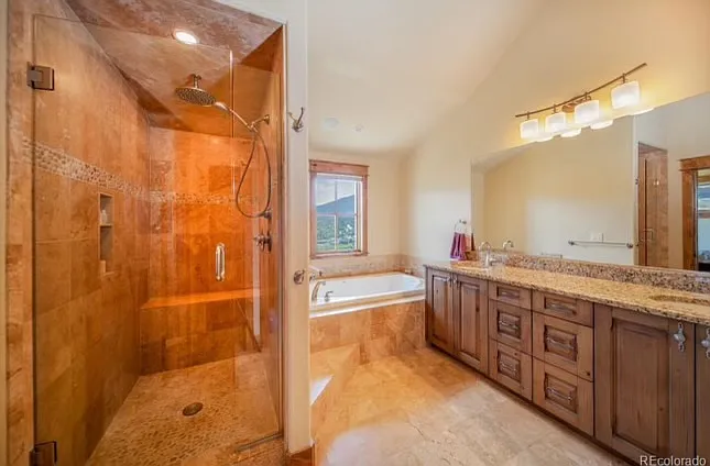 Primary ensuite with walk-in shower and soaking tub.