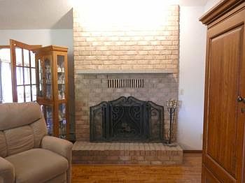 Nice brick wood burning fireplace in a spacious living room