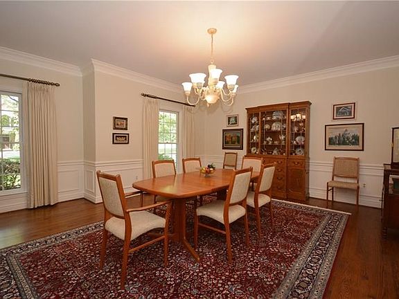 Gather in the large dining room with traditional molding.