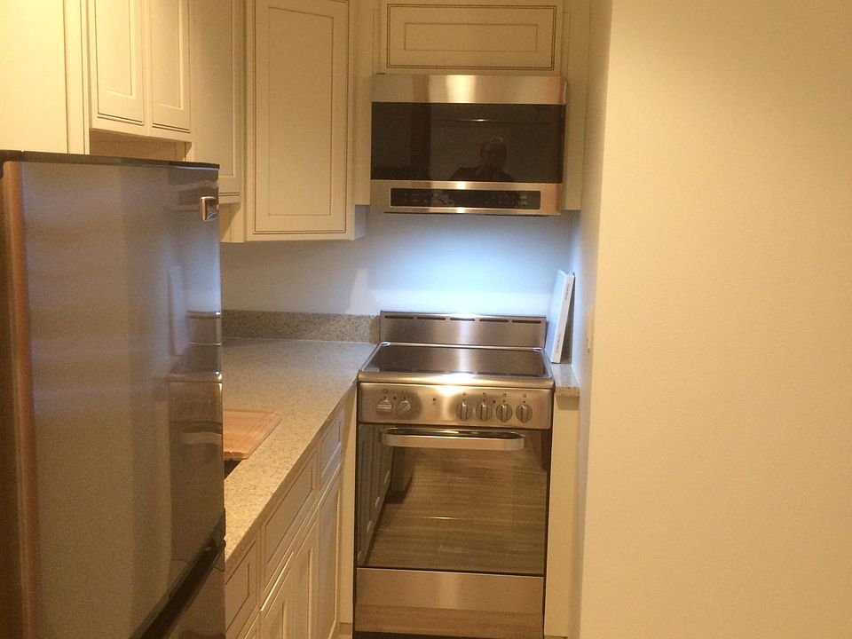 Kitchen showing glass top stove and built-in microwave