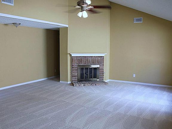 A closer look at the cozy fireplace & freshly painted Family Room. Recent carpet!