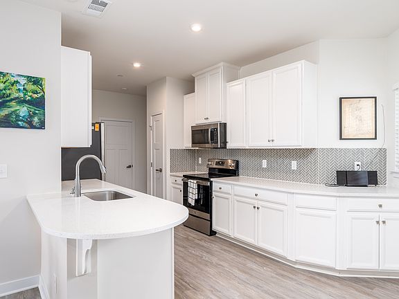 Fully equipped kitchen with modern applications and plenty of storage.