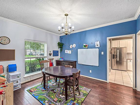 Immediately to the left of the front entry, the formal dining room is currently used as a home school classroom -- or it could easily be a spacious study or home office.
