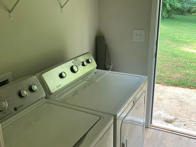 Laundry room and back door entrance. Laundry room is through the main bathroom.