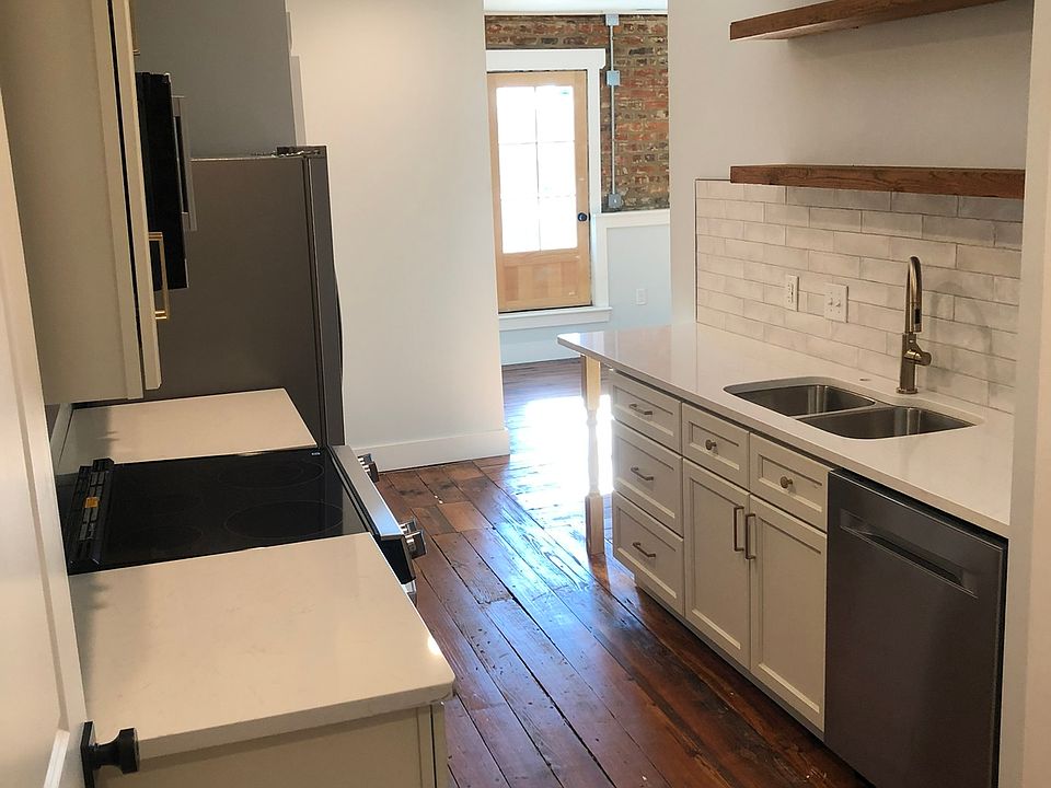 Enter the apartment into the galley kitchen. The large pantry is to the right of dishwasher seen in this view.