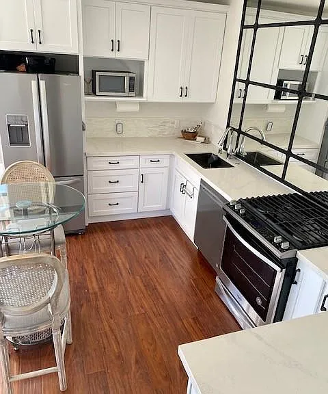 New Kitchen with tons of storage, slab quartz countertops, new stainless steel refrigerator, gas range, dishwasher, microwave. RH mirror to reflect the view. Rolling table and 2 chairs