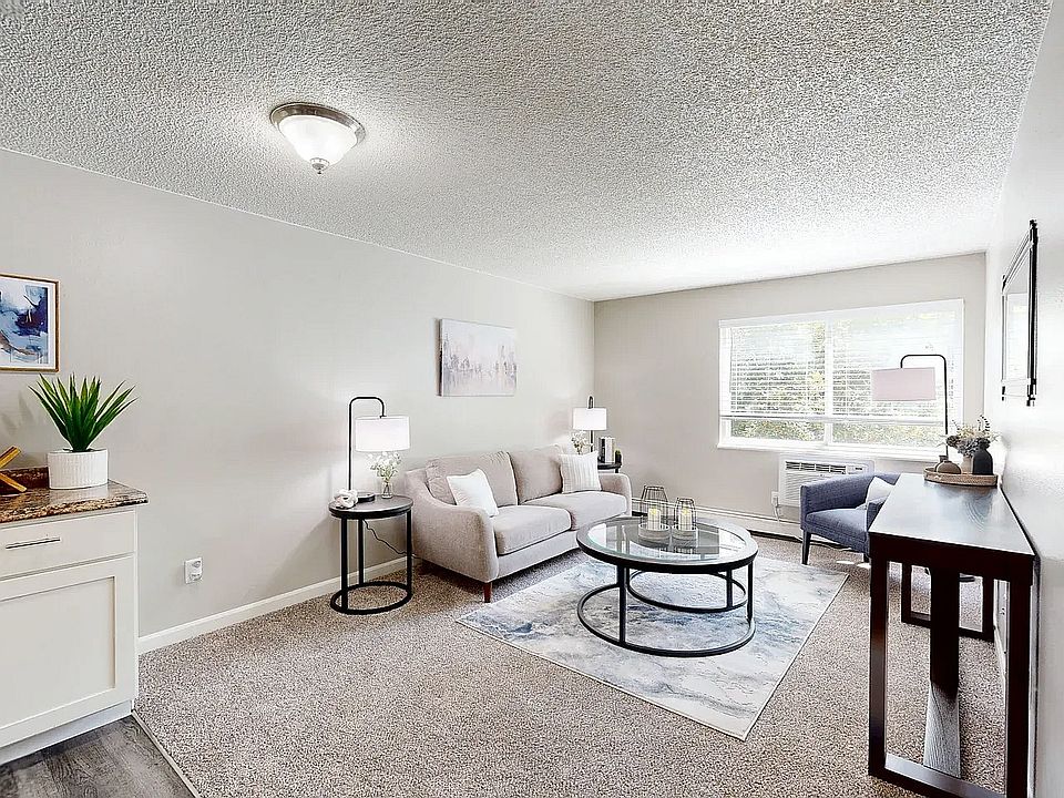 Spacious living room with natural light and stylish, modern furnishings