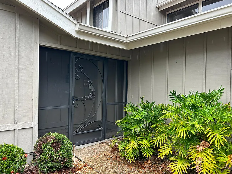 Screened in front entry. Main house to right garage to left