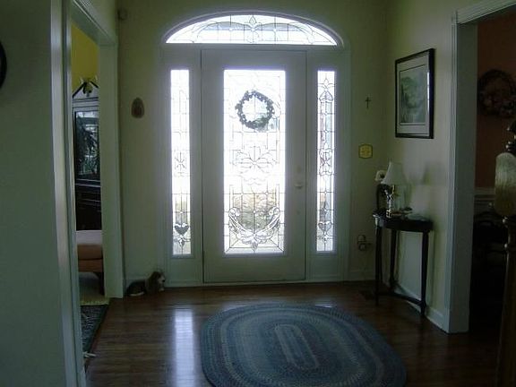 Entry hallway.  Door with glass, transom and side lights.